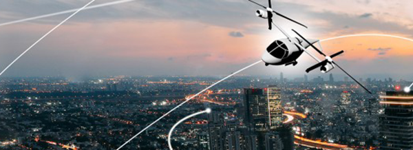A futuristic flying vehicle with rotors is flying over a cityscape at sunset, with light trails in the sky.