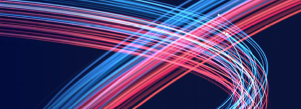 Curved streaks of blue and pink light intersect on a dark background, creating a dynamic, abstract pattern.