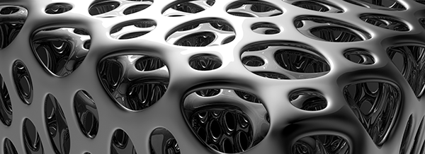 Abstract metallic structure with irregular, smooth holes and reflective surfaces, resembling an organic, porous material.